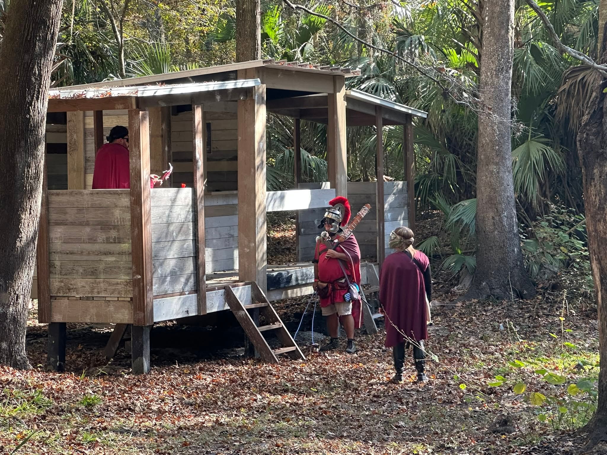 Legion members at a wooden fort structure