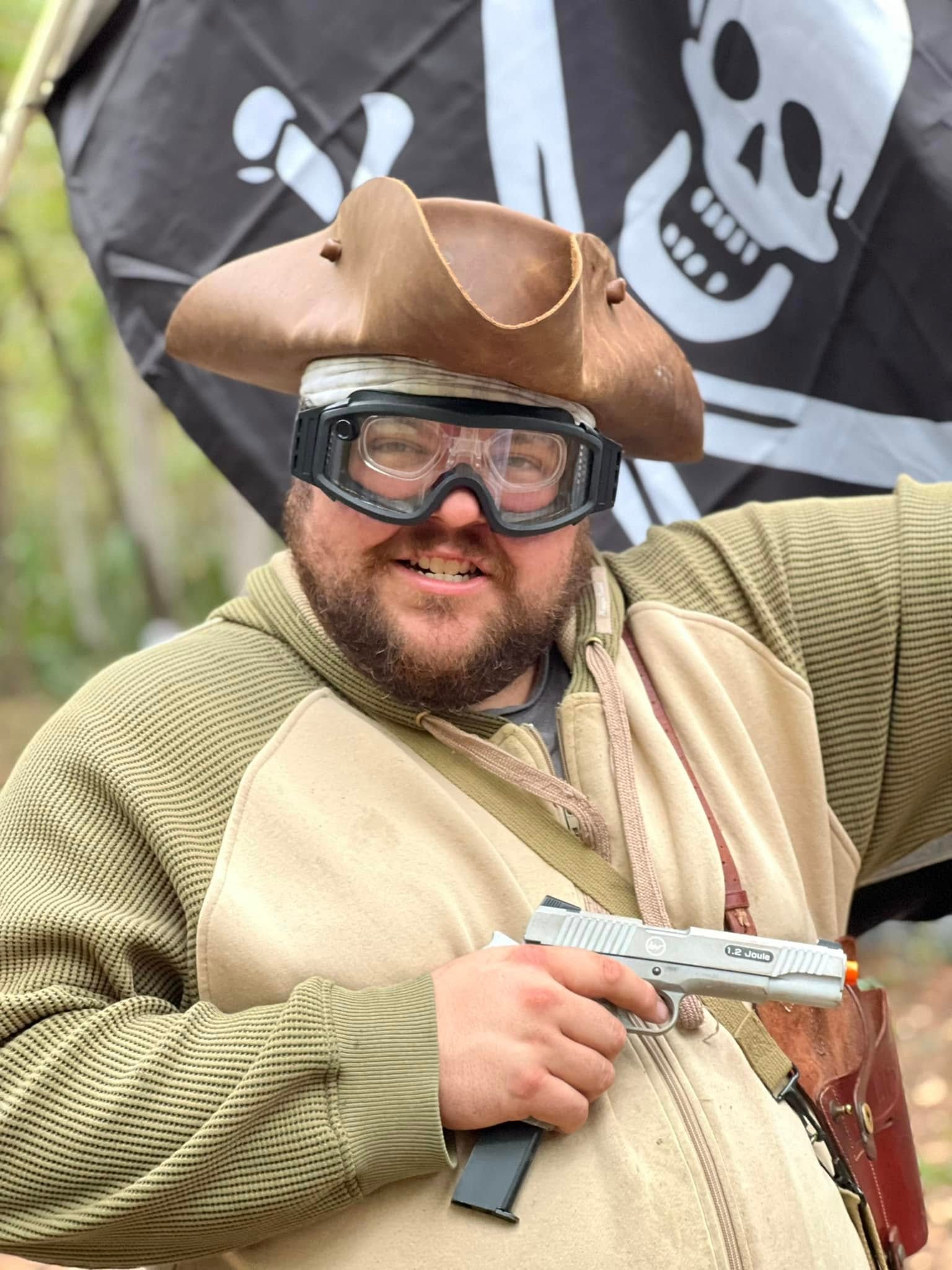 Ravager in tricorn hat with pistol and Jolly Roger flag at a MindGame Productions event